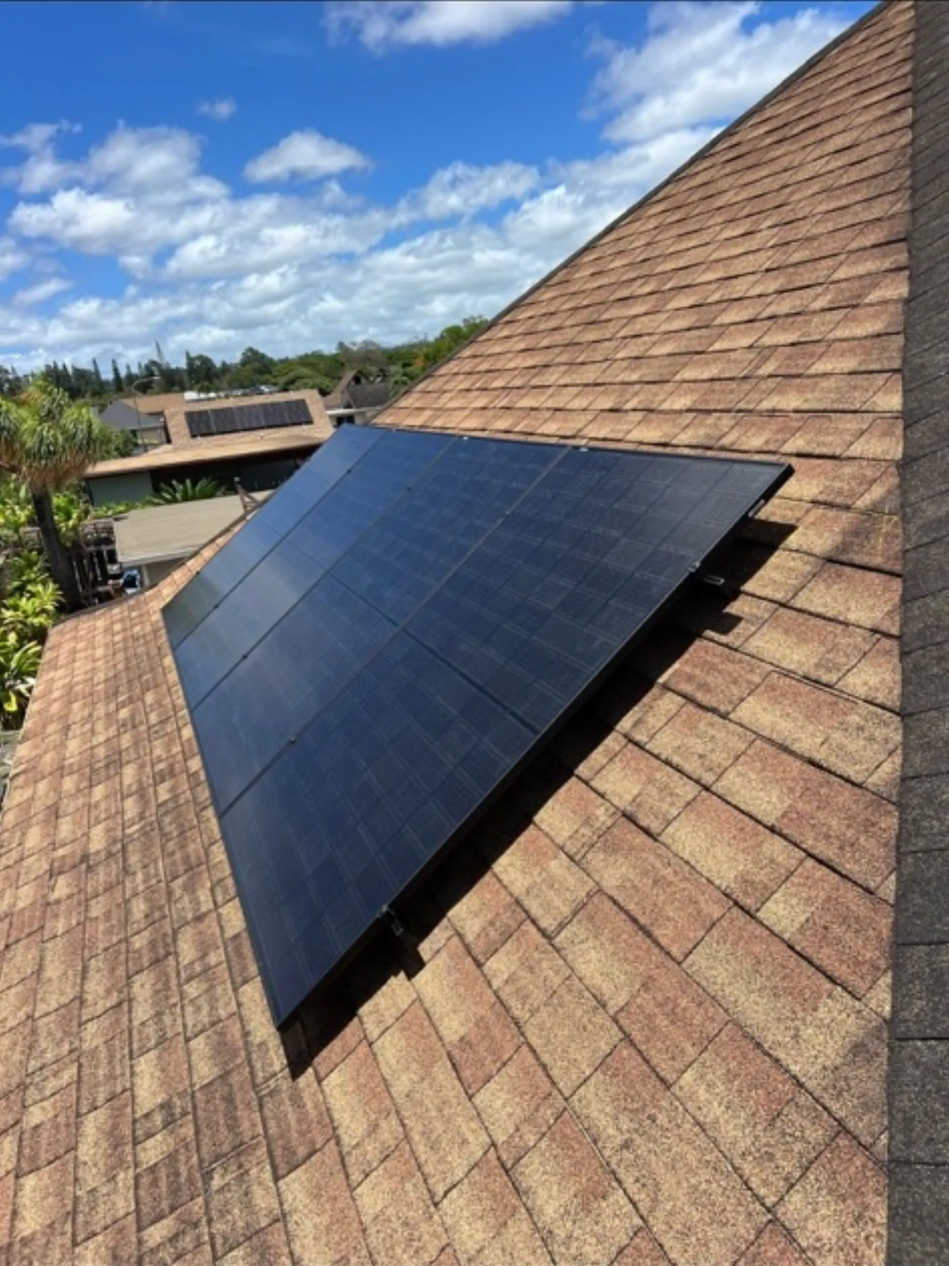 Rooftop solar panels under blue Hawaiian sky